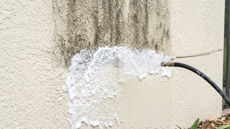 Foam detergent treating stucco before rinsing